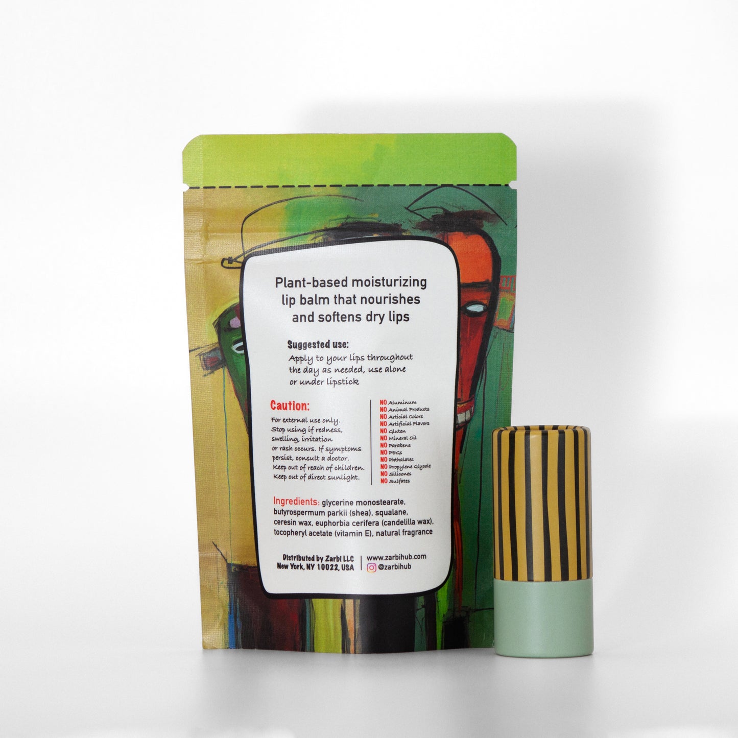 Twist-up Jasmine Green Tea lip balm tube with yellowish green cap, black stripes, mint base. Back side of stand-up green tear-off pouch with ingredients, instructions, Zarbi contact info.