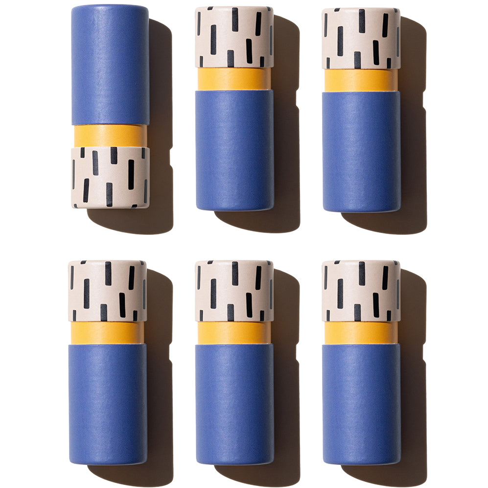 Graphic flat lay of Zarbi vegan lip balms in matte blue tubes with speckled black-and-beige bases and orange inner accents, arranged in a symmetrical grid on a white background.